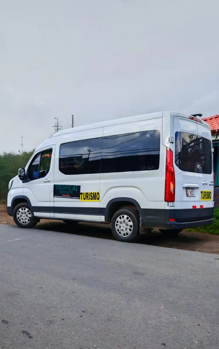 A white Tropical Experts Maxus van parked by the road