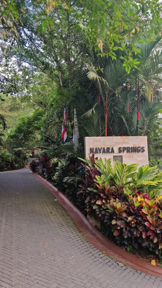 Nayara Springs entrance sign beside the driveway