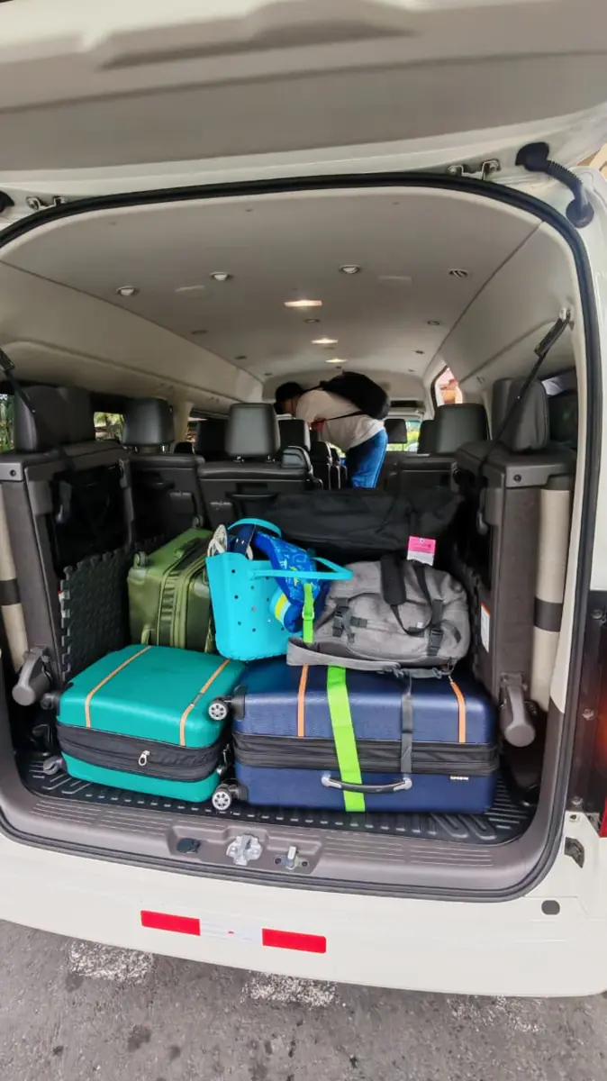 Suitcases loaded in the back of a Toyota Hiace