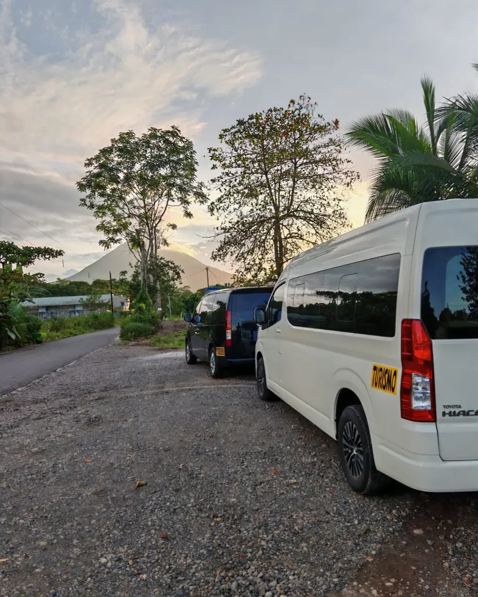 A white Toyota Hiace and a black Hyundai Staria parked on gravel