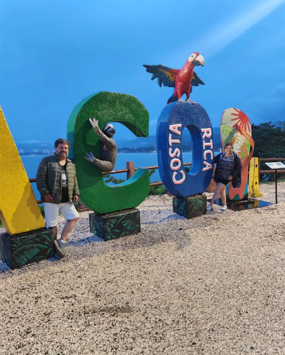 The Jacó letters at dusk, with the bay behind