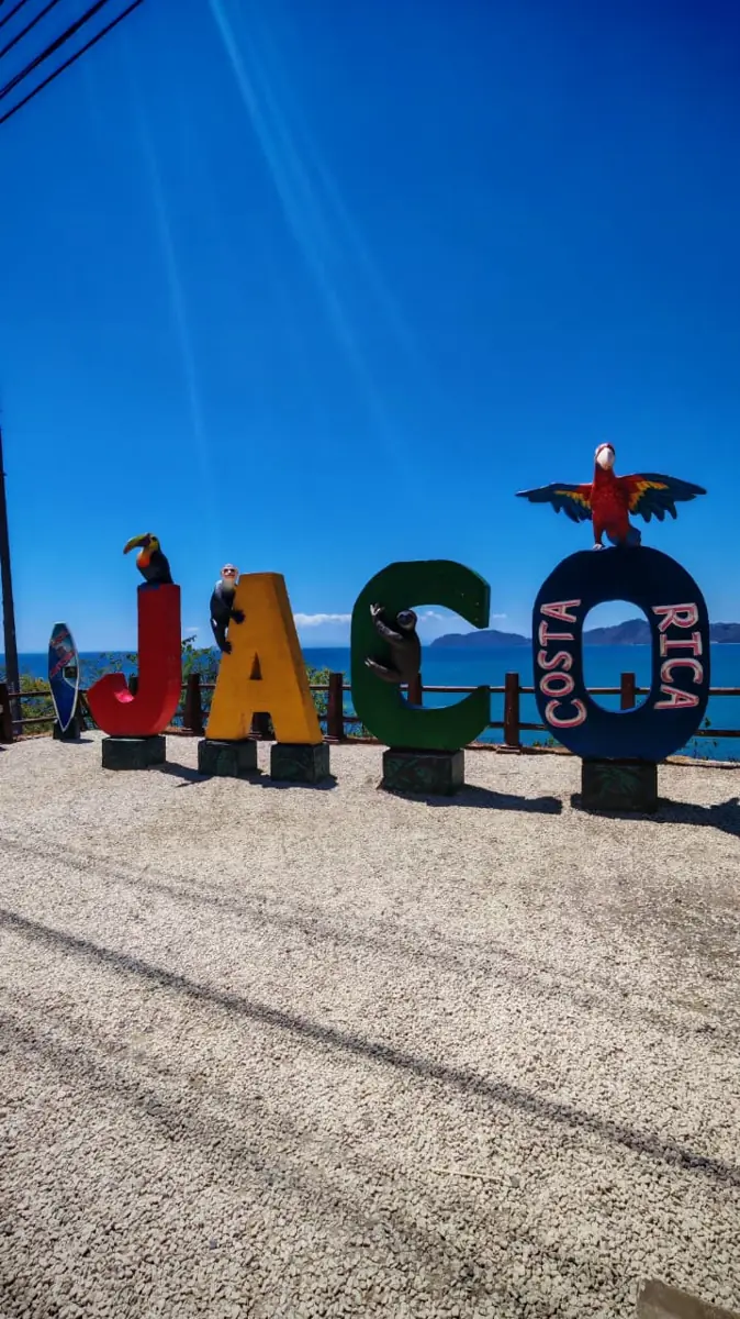The colourful JACÓ COSTA RICA letters with the Pacific behind