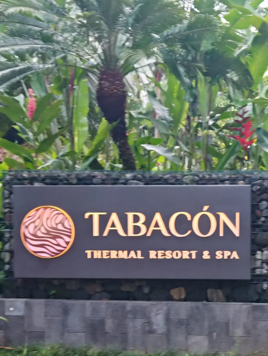 Tabacón Thermal Resort & Spa sign among tropical plants