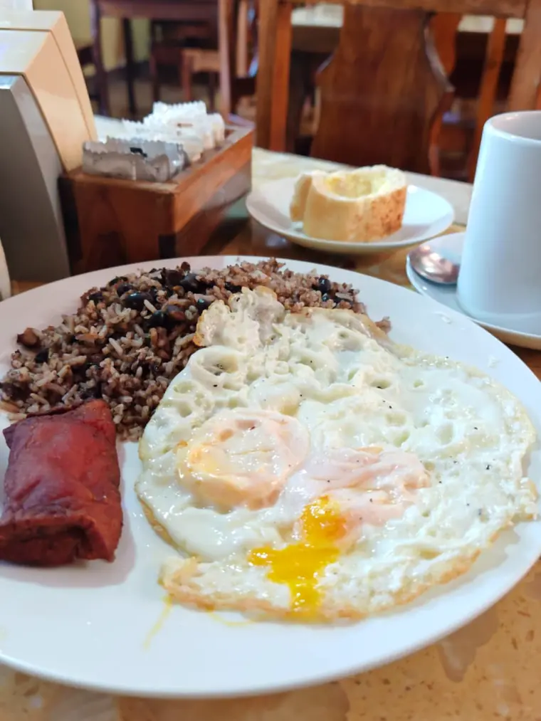 Gallo pinto con huevos fritos y salchichón, desayuno de soda
